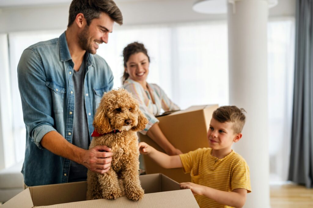 Husband and wife and their son with pet moving in new home