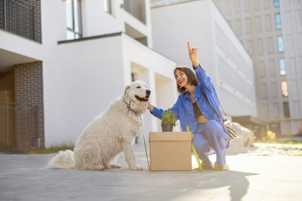 Woman with dog relocating to a new apartment