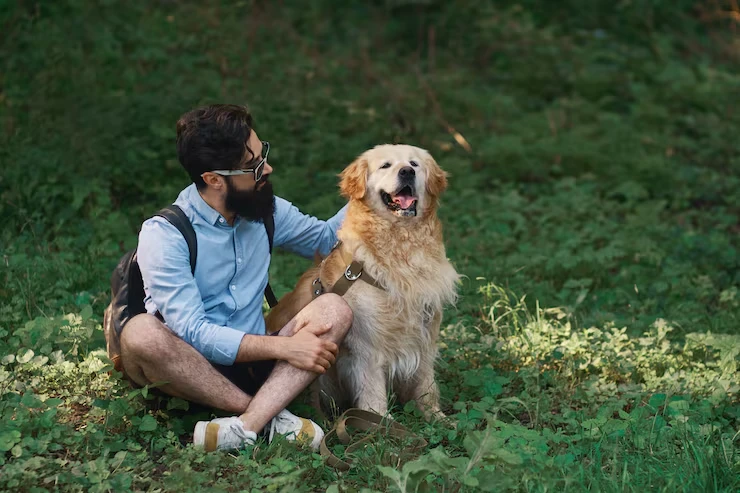 Man sitting with a happy dog.
