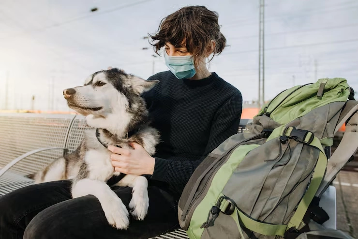 Person sitting with a dog outdoors.
